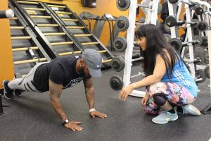 Image of a personal trainer working with a client on the National Personal Training Institute website