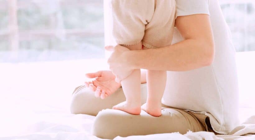 Image of a man with a baby standing on his leg on the National Personal Training Institute website