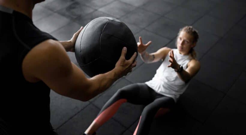 Image of a woman working with a personal trainer on the National Personal Training Institute website
