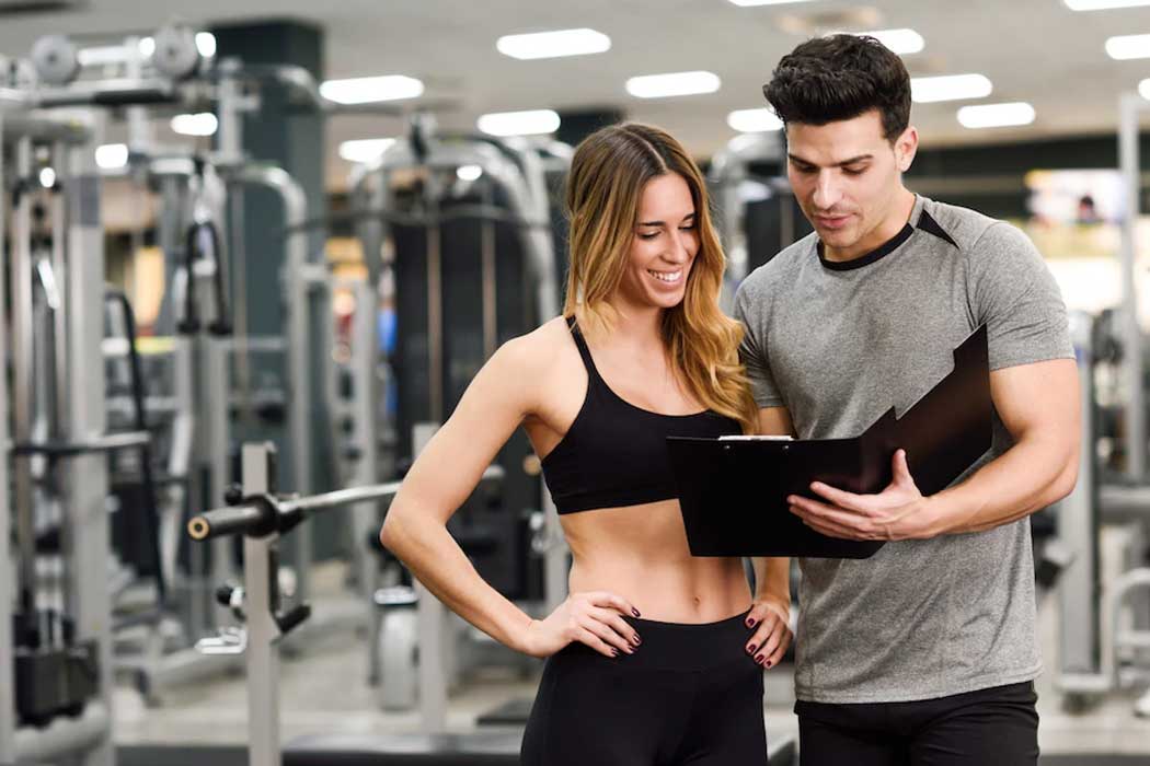 Image of a trainer working with a client on the National Personal Training Institute website