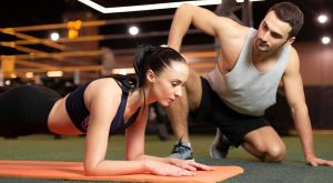 Image of a woman working with a personal trainer on the National Personal Training Institute website