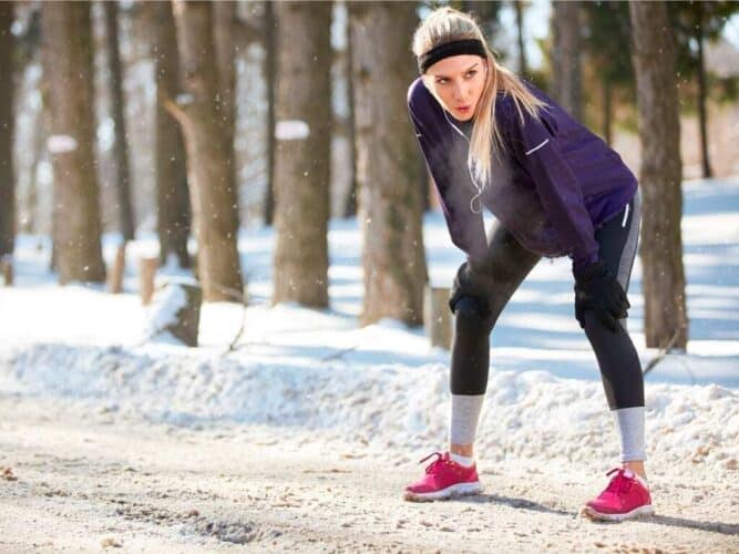 Image of a woman working out outside during winter on the National Personal Training Institute website
