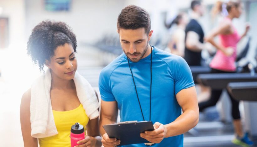 Image of a personal trainer working with a client on the National Personal Training Institute website