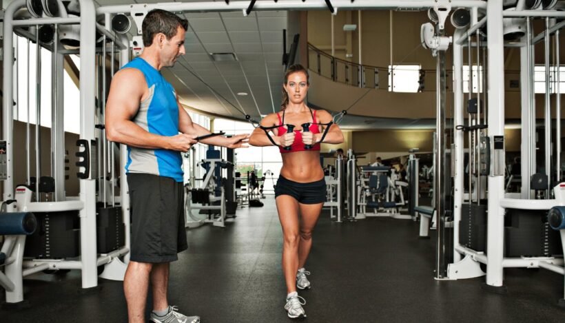 Image of a personal trainer working with a client on the National Personal Training Institute website