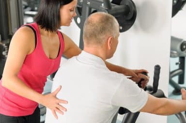 Image of a man working with a personal trainer on NPTI's website