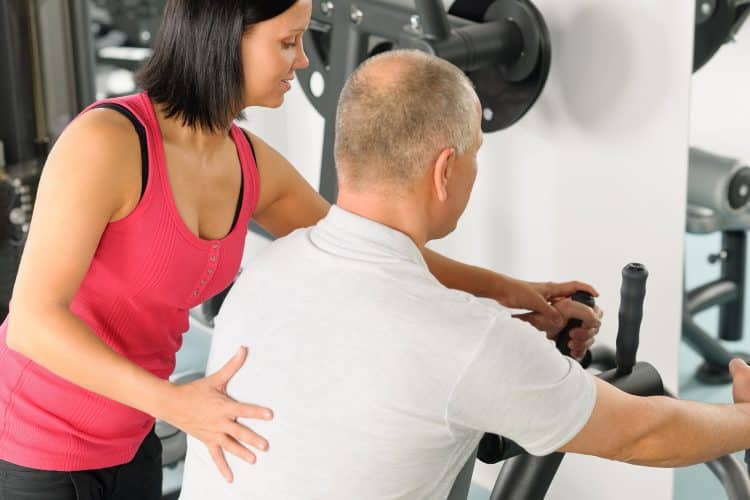 Image of a man working with a personal trainer on NPTI's website