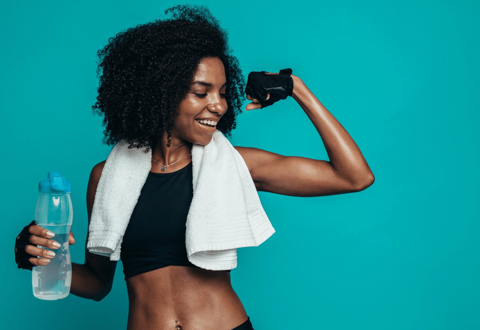 Image of a woman in workout clothes with a towel over her shoulders and a water bottle