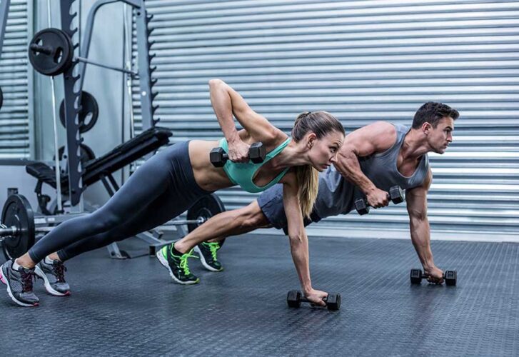 Couple doing plank exercise together