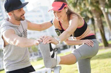 Fitness girl with coach exercising at the park