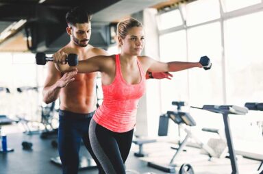 Personal trainer helping woman