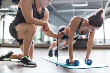 Woman exercising with dumbbells on mat